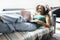 Pretty smiling african american woman is lying on the sofa with a laptop and headphones. Happy young woman enjoying music or