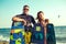 Pretty smiling couple kitesurfer enjoying summertime on beach