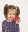 Pretty smiling girl teaches apple fruit