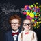 Pretty smiling kids school boy and girl on blackboard background with maths formulas and art pattern