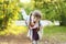 Pretty smiling little girl with braids depicts bird