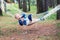 Pretty smilling boy resting on hammok in forest