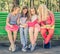 Pretty smilng little girls sitting together in the park