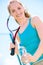Pretty sportswoman with racket on shoulders