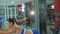 Pretty sportswoman stretching body in the gym. 4K