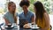 Pretty students hanging out in campus cafe using tablet