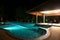 A pretty swimming pool in night at a local resort