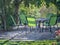 Pretty table and chairs under a green garden arbor