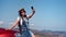 Pretty tanned smiling travel woman enjoying vacation taking selfie using smartphone medium shot