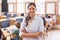 Pretty teacher smiling at camera at back of classroom