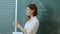 Pretty teacher talking to the pupils in classroom.