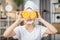 Pretty teen girl covering eyes with slices of oranges