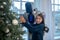 Pretty teen girl decorating the new year tree