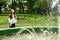 Pretty teen girl watch fountain in the park