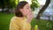 Pretty teenage girl blowing soap bubbles on a sunset. Child having fun in a park in summer.