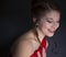 Pretty teenage girl laughing and wearing red prom dress