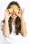 Pretty teenager girl covering her eyes with cut lemons. Lemon sunglasses