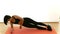 Pretty Thai Asian girl is doing side plank cardio workout exercise in white background in fitness show concept