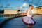 Pretty toddler girl in tutu skirt at sunset