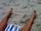 Pretty toes feet painted red nailpolish sand