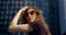 Pretty townswoman with sunglasses on her face is posing in front of skyscrapers in summer day