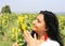 Pretty Turkish Woman  with red earrings  posing with sunflower