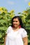 Pretty Turkish Woman  with red earrings  posing with sunflowers