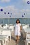 Pretty Turkish Woman with White Dress posing with charms  by the Lake