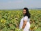 Pretty Turkish Woman   with White Dress posing with sunflowers