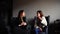 Pretty two girls discuss secrets of beauty and sit in gray armchairs in stylish cafe on winter day.n