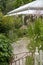 Pretty Victorian cottage surrounded by foliage in a garden