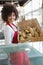 Pretty waitress carrying basket of bread