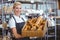 Pretty waitress carrying basket of bread