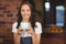 Pretty waitress offering a cup of coffee