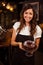 Pretty waitress presenting a chocolate cake