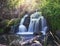 Pretty waterfall with slow shutterspeed for cascading water softening with a vintage retro instagram filter