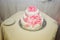 Pretty wedding cake decorated with pink and white ribbons and li