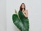 pretty woman attractive look palm leaf covers naked body