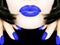 pretty woman with black bob hair blue smerf lips fingernails sending a kiss smooch