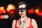 Pretty woman brunette model in black carnival mask on abstract night glitter bokeh background