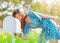 Pretty woman is checking her white mail box in a country farm house field