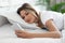 Pretty woman checking smartphone in bed, closeup