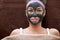 Pretty woman with cosmetic black mask on face