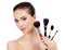 Pretty woman with cosmetic brushes