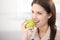 Pretty woman eating green apple smiling