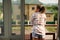 Pretty woman enjoys the beautiful morning sun on her balcony in a country house