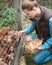 Pretty woman farmer female gathering fresh eggs into basket at h