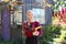 Pretty Woman Gardener Smiles as She Carries Flowers Outside in Her Cottage Garden