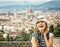 Pretty woman happily laughs with the city of Florence behind her