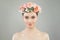 Pretty woman with healthy skin and rose flowers wreath portrait. Pretty candid girl with flowers. Facial treatment